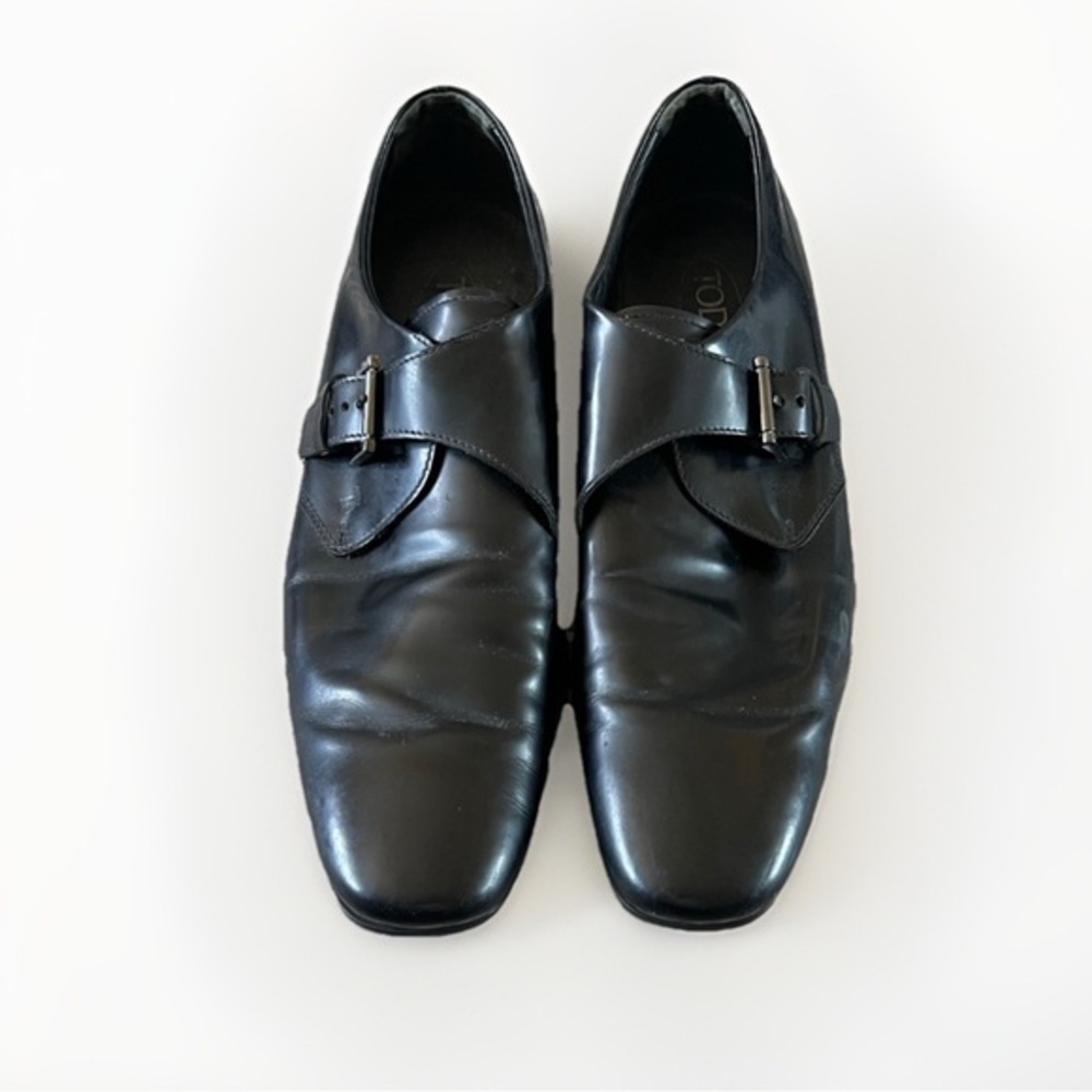 Tod’s black buckle loafers